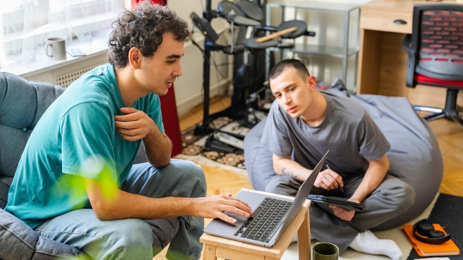 Two roommates hang out in the living room of a sober living house.