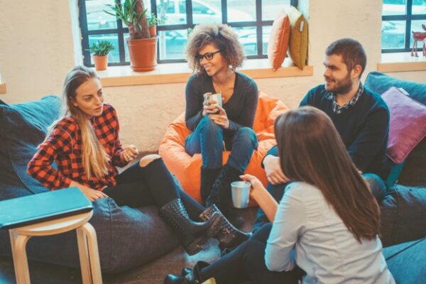 A group of people sitting and having a conversation.